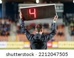 Small photo of Sideline referee shows 4 minutes added time during the football match.