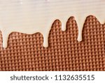 Small photo of White hot chocolate on the wafer. Waffle covered with condensed milk close-up. White hot chocolate spreads on the wafer.