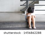 Small photo of Asian child touchy or kid girl sleeping and angry cry with sad or have problems and bend down the head lonely to wait for the parents on city street at nursery or kindergarten and pre school