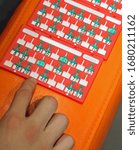 Small photo of bingo scorecards and the hand of young player