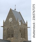 Small photo of Sainte-Mere-Eglise, FRA, France - August 21, 2022: DDAY Memorial with Paratrooper on the bell tower