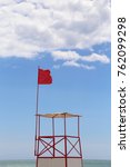 Lifeguard Tower With Red Flag...