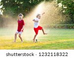 Kids Play With Water On Hot...