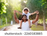 Small photo of Father and son in sunny park. Loving family playing outdoor. Dad holding little boy high in the air. Young man and his adorable little boy play and laugh. Happiness and love. Happy fathers day.
