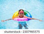 Small photo of Child in swimming pool floating on toy ring. Kids swim. Colorful rainbow float for young kids. Little girl having fun on family summer vacation in tropical resort. Beach and water toys. Sun protection