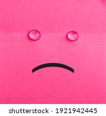 Small photo of Unhappy sticky note. Pink paper. Tears. Hapless concept.