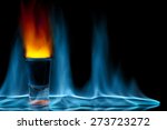 shot glass on fire against black background