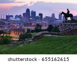 View of Kansas City, Missouri skyline at dawn during golden light from the Kansas City Scout Memorial with all registered trademarks removed.