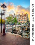 Amsterdam. Holland. Downtown of Amsterdam. Traditional houses and bridges of Amsterdam. A colorful sundown time.  Virtical