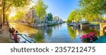 Small photo of Soul of Amsterdam. Early morning in Amsterdam. Ancient houses, bridges, traditional bicycles, canals, boats. Panoramic view with all the sights of Amsterdam. Holland, Netherlands, Europe.