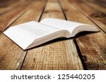 Open Book On Wood Background