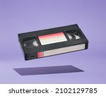 VHS video cassette hovers above the surface. Retro dreamy design. Fun with friends and positive mood.