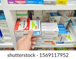 Small photo of Bangkok,Thailand-February 23,2019: Pharmacist holding Zithromax box from Pfizer and many medicines on shelf in pharmacy drugstore.Zithromax is used to treat many different kinds of bacterial infection