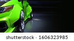 Small photo of Front headlights of green modify car on black background,copy space