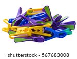Plastic pegs of different shapes and colors isolated on a white background.  Background texture of various types of multicolored clothespins or clothes pegs close-up. Side view