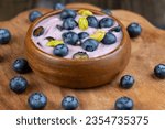 fresh blueberry-flavored yogurt with ripe blueberries and pistachios, natural yogurt with fresh blueberries and pistachio nuts