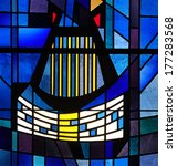 Small photo of Modern stained glass window depicting a harp and a musical staff with square notation used in traditional Gregorian chant, located in Benedictine monastery in Erie, Pennsylvania