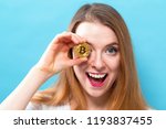 Woman holding a physical bitcoin cryptocurrency in her hand