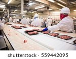 Workers Handle Meat Organizing...