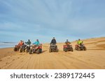 Small photo of A group of tourists enjoys quad biking along Essaouira's oceanfront, creating an adventurous spectacle against the scenic coastal backdrop