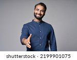 Small photo of Smiling indian business man investor, happy ethnic businessman employer, professional hr manager or salesman extending hand for handshake welcoming offering cooperation isolated on gray, portrait.