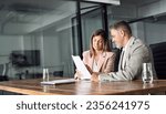 Small photo of Two professional executives discussing financial accounting papers working with paperwork in office. Mature business woman and man managers holding legal corporate documents at meeting. Copy space.