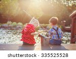 Two Kids Boy And Girl Fishing...