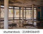 Small photo of an old abandoned and ruined building with a wet ceiling and puddles on the floor. destruction, poverty and war. rehabilitation and reconstruction of premises.