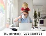 Small photo of Man is working from home with laptop during quarantine. Home office and parenthood at same time. Exhausted parent with hyperactive child. Chaos with kids during isolation