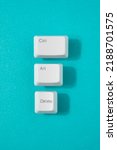 Small photo of Control, alt and delete retro keys on a teal background. Reset, recession minimal concept.