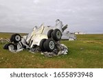 Plane crash. Parts of the destroyed aircraft, landing gear and fuselage, lie in the field