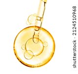 Small photo of golden miracle yellow bubble vitamin oil or serum isolated on white background with laboratory glass pipette on white background. Beauty and skincare