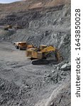 Small photo of Open pit mining of iron ore and magnetite ores.Loading the iron ore into heavy dump truck at the opencast mining.