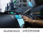 Self Driving car with futuristic graphic of GPS system driving on street in the city with Autopilot Mode. AI Technology with transportation concept.