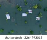 Small photo of Top view of house roof drown after hurricane impact. Extreme weather and Climate change impact.