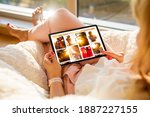 Woman sitting at home and browsing beautiful portrait photos online