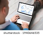 Man using CRM software on laptop with different graphs and charts showing sales data for his business
