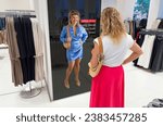 Small photo of Woman viewing interactive mirror screen in retail store showing personalized offers
