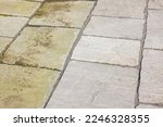Small photo of Cleaning sandstone paving. Garden patio before and after jet washing or pressure washing, UK.