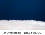 Fluffy fur on blue background with copy space.