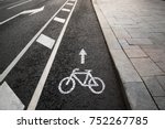 Separate bicycle lane for riding bicycles. White painted bike on asphalt. Ride ecological green urban transport