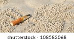 Cigarette Butt In Sand. Litter...