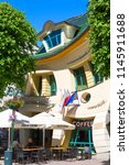 Small photo of SOPOT, POLAND - JUNE 6, 2018: Krzywy Domek ( crooked little house ) at Monte Cassino Street. It is an unusually shaped building, built in 2004