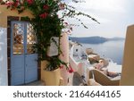 Small photo of traditional greek village Oia of Santorini, beautiful street against Aegan sea and caldera, Greece, web banner format