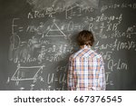 Teenageer Boy having trouble with complicated math formulas on black board