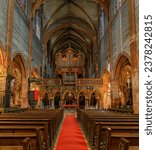 Small photo of Strasbourg, France - May 31, 2023: Nave, a gothic archway of the rood screen and an ornate organ in the Saint Pierre le Jeune Protestant church