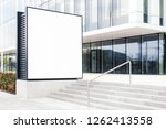 Large blank outdoor billboard template with white copy space to add multiple company names and logos with modern office building in background