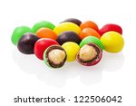 Peanuts covered with multicolored glaze on a white background