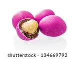 Peanuts covered with pink glaze on a white background