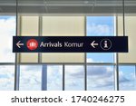 Arrivals sign at an airport in English and Icelandic. Komur translates to arrivals.